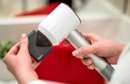 a person is holding a hair dryer at Saint John's Resort in Plymouth