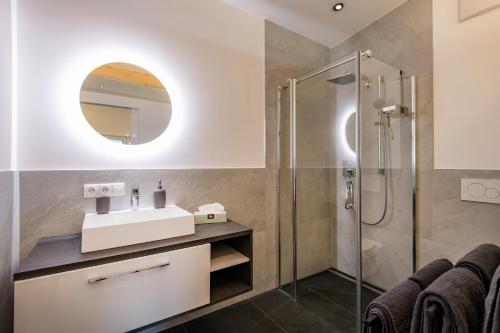 a bathroom with a sink and a shower at Ferienwohnungen N & C in Sankt Johann in Tirol