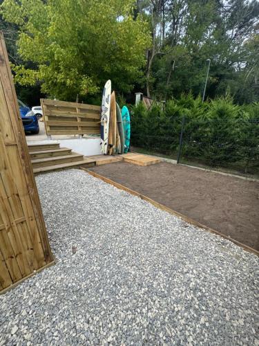 a group of surfboards sitting next to a bench at L'orangerie in Seignosse