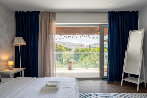 Postel nebo postele na pokoji v ubytování Alia Apartment