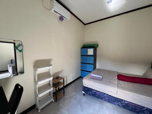 a small room with a bed and a mirror at Parkside nest-studio 3 in Kuta Lombok