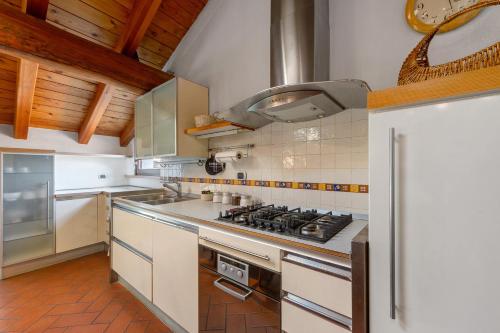 a large kitchen with a stove top oven at La Mansarda del Viaggiatore in Pont-Saint-Martin