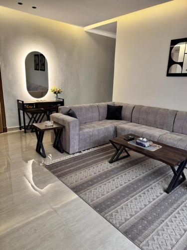 a living room with a couch and a table at Luxury Apartment with 3 bed room in Al Khobar