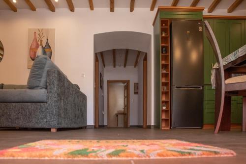 a living room with a couch and a refrigerator at Heliades NeoClassical in Panteli