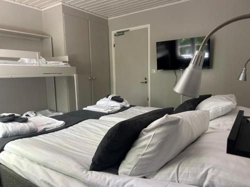 a bedroom with two beds with towels on them at STF Korrö Gårdshotell - B&B in Linneryd