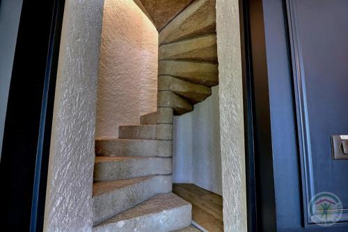 a spiral staircase is seen through a glass door at Manoir de la droulinais in Bruz