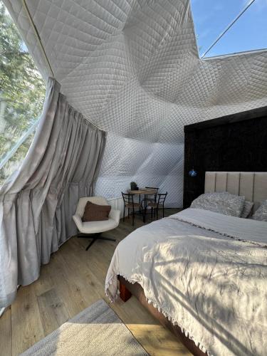 a bedroom with a bed with a mosquito net at Vesturás lodge in Hella