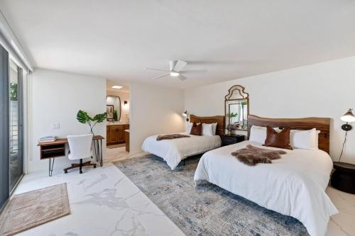 a hotel room with two beds and a desk and a desk at Tranquil & Spacious, Newly Updated,great Location in Indian Wells
