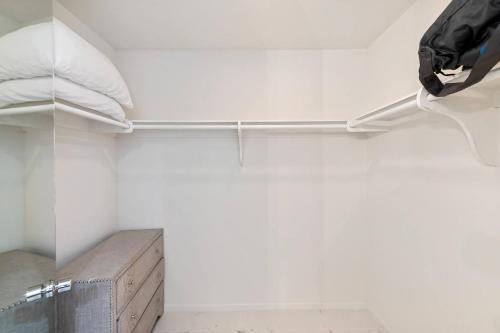 a bedroom with white walls and a bed with white pillows at Tranquil & Spacious, Newly Updated,great Location in Indian Wells