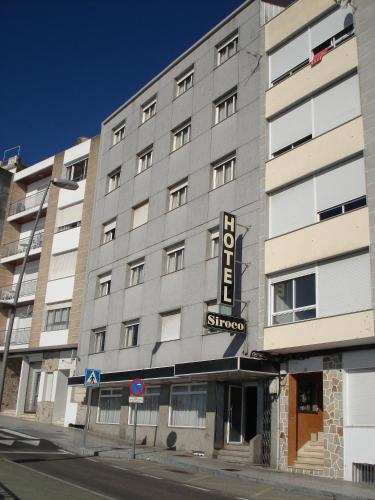 a building with a sign on the side of it at Hotel Siroco Portonovo in Sanxenxo