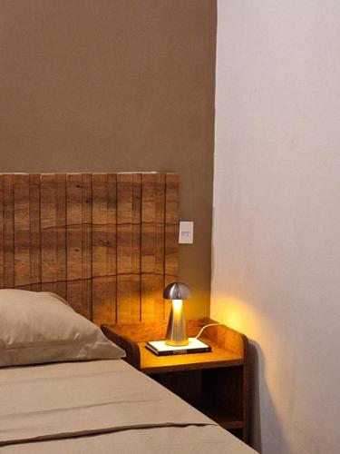 a bedroom with a bed and a lamp on a night stand at Makasi Zanzi - Minimalist apartment in Jambiani Village in Jambiani