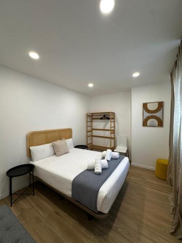 a bedroom with a bed with towels on it at VTZ Los Balcones del Casco in Zaragoza