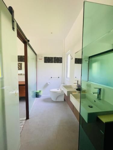 a bathroom with a toilet and a sink and a tub at Jungle Breeze Bungalow, Fast WiFi, Quiet Retreat in Ban Dan Mai