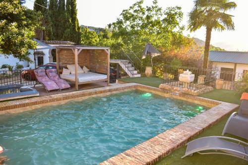 a swimming pool with a gazebo in a yard at Casa Rural Arados in Priego de Córdoba
