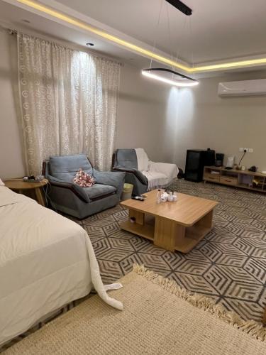 a bedroom with a bed and a couch and a table at Safety house in Tabuk