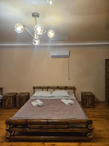a bedroom with a bed with two towels on it at Broliskedi inn 