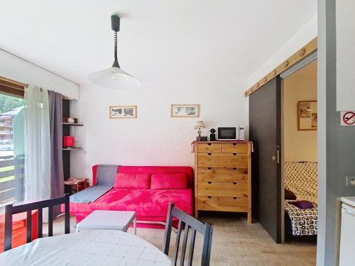 un salon avec un canapé rouge et une chambre dans l'établissement Portes Du Soleil PSB187 TELECABINE & MOUNTAIN 4 Per, à Châtel