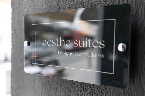 a sign on a wall that reads assistive suites designed for illness at Aesthe Suites Noir in Xanthi