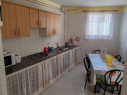 a kitchen with a counter and a table with a microwave at House Rural,Biosphere Reserve World.Taganana.Tfe. in Santa Cruz de Tenerife