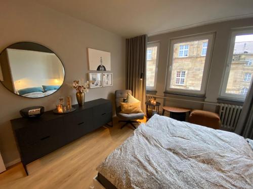 a bedroom with a bed and a large mirror at Modernes Apartment no5 in bester Stadtlage in Kassel