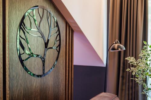 a door with a stained glass picture of a tree at Salt Lake Hotel in Sovata