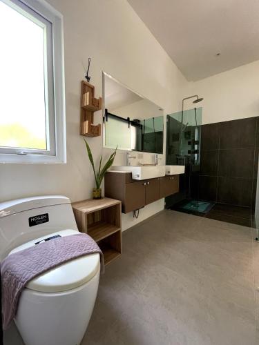 a bathroom with a toilet and a sink and a mirror at Jungle Breeze Bungalow, Fast WiFi, Quiet Retreat in Ban Dan Mai