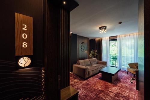 a living room with a couch and a chair at Salt Lake Hotel in Sovata