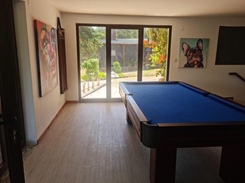 a room with a pool table in front of a door at Abadia House - Geres in Geres
