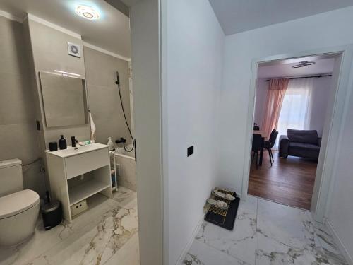 a bathroom with a toilet and a sink and a mirror at Apartament nou si modern lanaga metrou in Bucharest