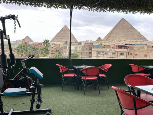 a view of the pyramids from the balcony of a restaurant at Master Kings of the pyramids and Sphinx in Giza
