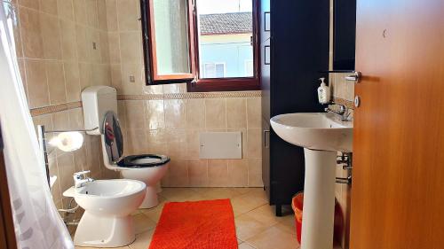 a small bathroom with a toilet and a sink at Residence MARISOL in Cesenatico