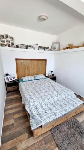 a bedroom with a bed and a wooden floor at Kotor Bay View Apartments in Bijela