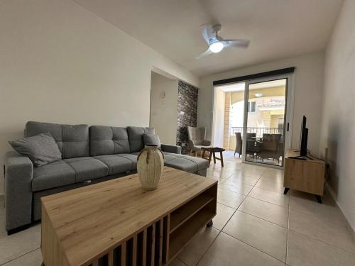 a living room with a couch and a coffee table at Majestic Gardens 10 minutes from Larnaka Airport in Tersephanou