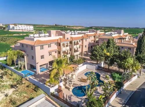 an aerial view of a large house with a swimming pool at Majestic Gardens 10 minutes from Larnaka Airport in Tersephanou