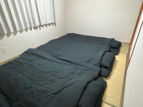 a small bedroom with a bed in the corner at ラ モンターニュ in Sapporo
