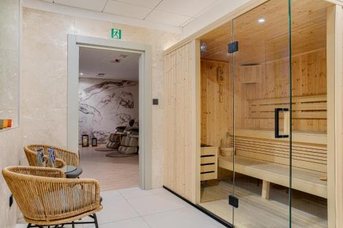 a room with glass doors and chairs and a table at Hotel ETER in Toruń
