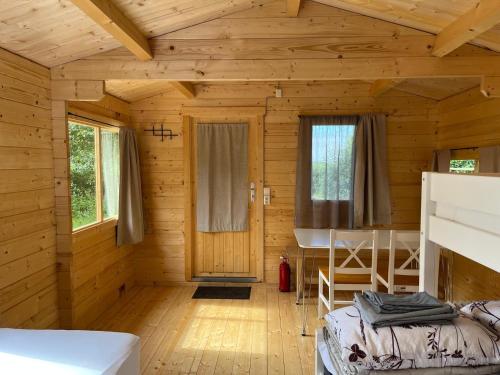 a bedroom in a log cabin with a bunk bed at Búdardalur glamping in Búðardalur