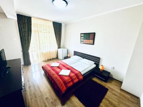 a bedroom with a bed with a red blanket at Pensiunea Amnesia in Sovata