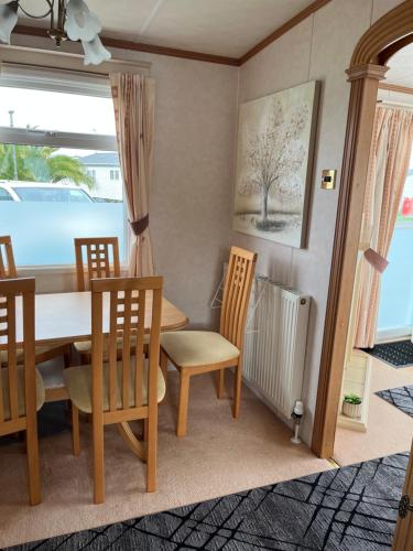 a dining room with a table and chairs at 2 Bedroom Mini Lodge near the beach in Walton-on-the-Naze