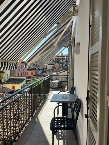 a balcony with a table and chairs on a building at The loft in Carpaneto Piacentino