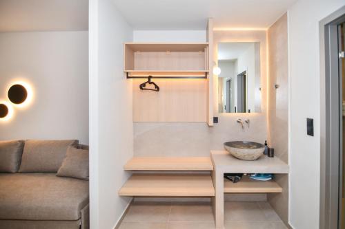 a bathroom with a sink and a couch at Thrive in Sarti