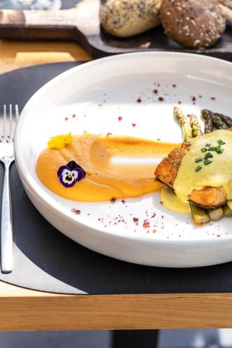 a white plate with food on a table at Pearl SeaBreeze Suites in Rethymno Town