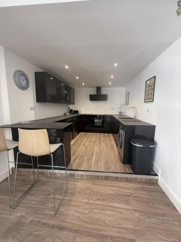a kitchen with a table and chairs in a room at Stylish 3 bed spacious flat in Brentwood