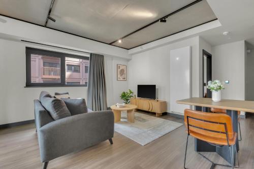 a living room with a couch and a table at Chic Luna Apartments near Wembley Park by MySquare in London