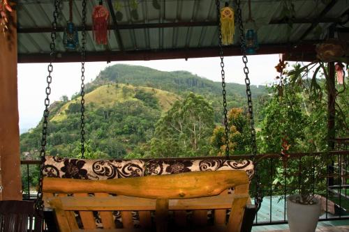 a porch swing with a view of a mountain at Secret View Homestay Ella in Ella