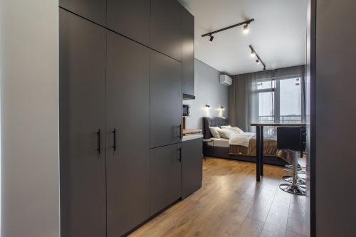 a room with a large cabinet and a bedroom at Rodos ArCadia Apartments in Odesa