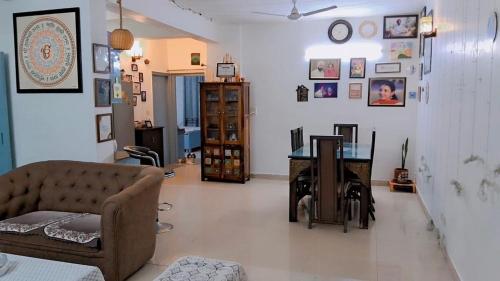 a living room with a couch and a desk at Modern 2BHK Comfort Home in Mohali