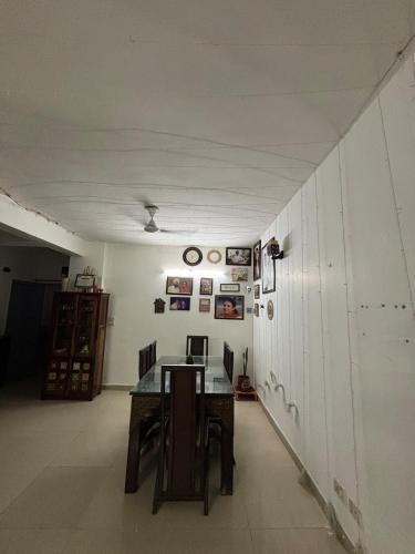 a room with a table and chairs and a wall at Modern 2BHK Comfort Home in Mohali