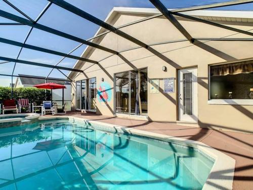 a swimming pool with a glass roof at Orlando area villa w pool, spa & arcade in Orlando