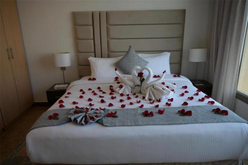 a bedroom with a bed with flowers on it at Best Western Plus Mahboula in Kuwait
